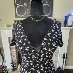 Black dress with flowers, neckline on the chest and back.  Size: Small